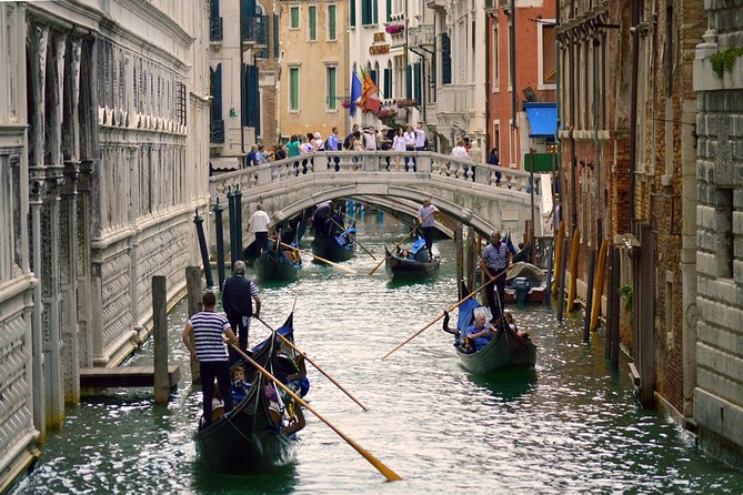 Gondolas under a bridge on a Venice side canal